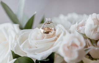 wedding bands on white flowers